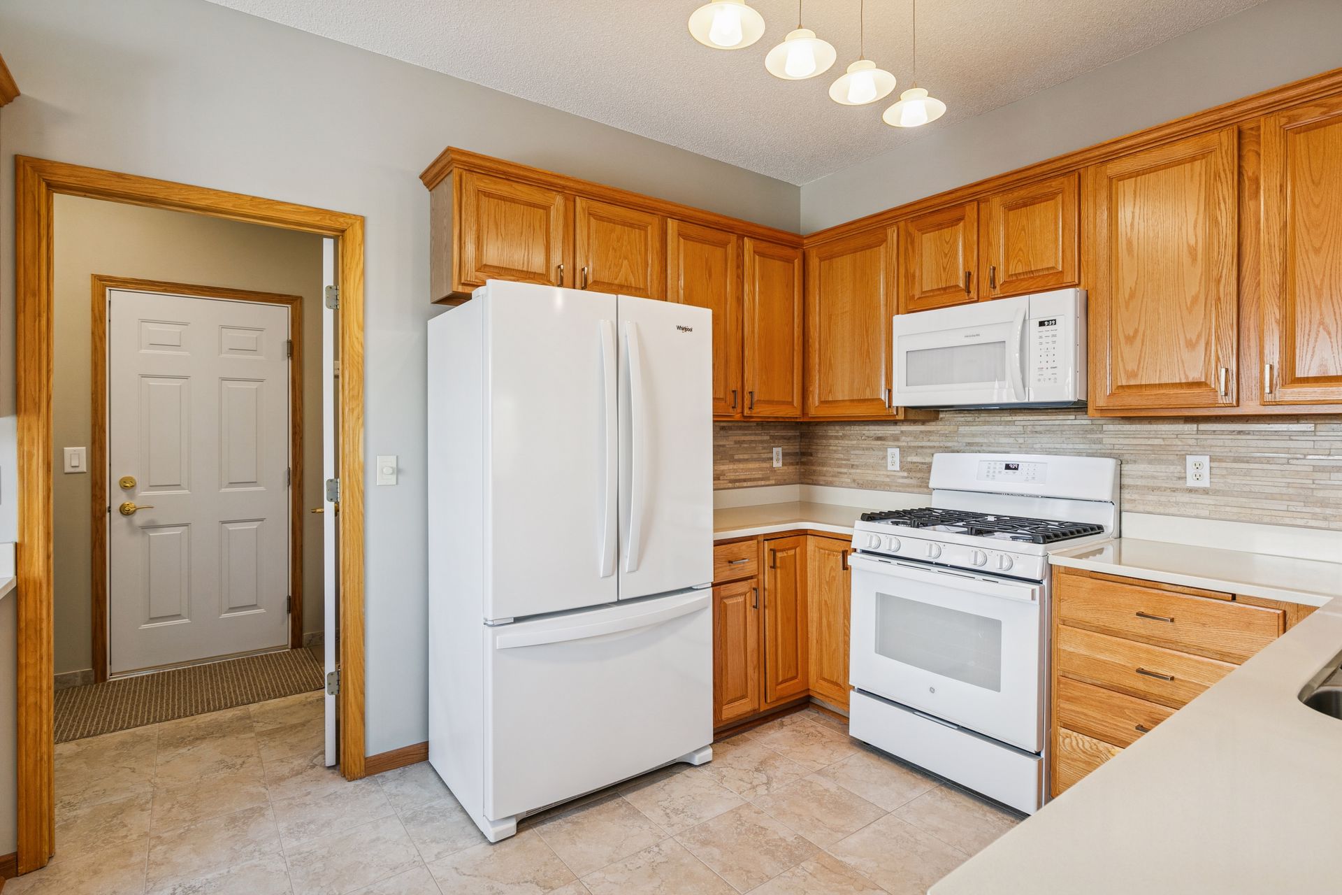 Kitchen with tri-door fridge